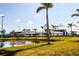 Ballpark view showcasing the stadium by a pond with surrounding palm trees at 734 Brightside Crescent Dr # 18, Venice, FL 34293