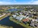 Aerial view of the home showcasing its location with a lake view and the surrounding community at 734 Sugarwood Way, Venice, FL 34292