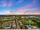 Expansive aerial perspective showcases a coastal community, waterfront views, and a prominent water tower at 734 Sugarwood Way, Venice, FL 34292