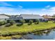 Aerial view of the property highlighting its waterfront location, spacious backyard, and screened-in lanai at 734 Sugarwood Way, Venice, FL 34292