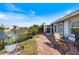 Serene backyard with brick pavers, a tranquil lake view, and comfortable outdoor seating at 734 Sugarwood Way, Venice, FL 34292