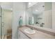 Bright bathroom featuring a large vanity, a spacious shower with a bench, and a bright mirror at 734 Sugarwood Way, Venice, FL 34292