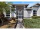 Charming home entryway with a decorative front door, landscaped surroundings, and a welcoming ambiance at 734 Sugarwood Way, Venice, FL 34292