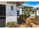 Close up of the exterior of the home with beautiful landscaping and an accent light fixture at 734 Sugarwood Way, Venice, FL 34292