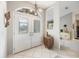 Bright foyer featuring double doors with decorative glass and tiled flooring leading into the main living spaces at 734 Sugarwood Way, Venice, FL 34292