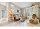 Inviting sitting room featuring neutral tones, tile flooring, and natural light from an arched window at 734 Sugarwood Way, Venice, FL 34292