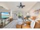 Bright living room featuring a ceiling fan, plush seating, and sliding glass doors to the outdoors at 734 Sugarwood Way, Venice, FL 34292