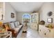 Cozy seating area with a wicker couch and bright, natural light from a large window at 734 Sugarwood Way, Venice, FL 34292