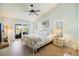 Serene main bedroom features sliding glass doors to a private lanai overlooking a tranquil pond at 734 Sugarwood Way, Venice, FL 34292