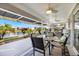 Covered patio with outdoor seating, overlooking a tranquil pond and lush landscaping at 734 Sugarwood Way, Venice, FL 34292