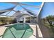 Relaxing screened-in pool surrounded by tropical landscaping, ideal for enjoying the Florida lifestyle at 734 Sugarwood Way, Venice, FL 34292