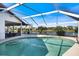 Beautiful screened-in pool offering clear blue water and views of the tranquil waterfront at 734 Sugarwood Way, Venice, FL 34292