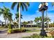 Charming street view with palm trees, quaint shops, and a vintage clock adding to the scenic downtown atmosphere at 734 Sugarwood Way, Venice, FL 34292