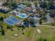 Aerial view of community including tennis courts, golf course, and pool at 748 White Pine Tree Rd # 208, Venice, FL 34285