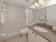 Bright bathroom features a tiled shower, neutral countertops, and a large mirror at 748 White Pine Tree Rd # 208, Venice, FL 34285