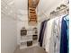 Spacious closet with shelves and hanging space; ladder provides access to attic storage at 748 White Pine Tree Rd # 208, Venice, FL 34285