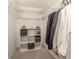 Walk-in closet provides ample storage with shelving and hanging space for clothing at 748 White Pine Tree Rd # 208, Venice, FL 34285