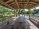 A covered pool-side gazebo boasts a large picnic table for entertaining by the lake and community pool at 748 White Pine Tree Rd # 208, Venice, FL 34285