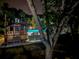 Nighttime view of the pool area with a charming gazebo lit up at night at 748 White Pine Tree Rd # 208, Venice, FL 34285