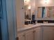 Bathroom featuring a white vanity with a sink and a mirrored medicine cabinet at 749 N Green Cir, Venice, FL 34285