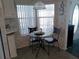 A bright breakfast nook with seating for two, next to the kitchen at 749 N Green Cir, Venice, FL 34285