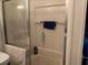 Bathroom showcasing a shower stall with a glass door and white surround at 749 N Green Cir, Venice, FL 34285