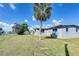 Wide view of the backyard showing the home's rear facade and surrounding greenery at 7903 Hyde Park Ave, North Port, FL 34287