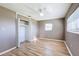 Bedroom with wood-look floors, a closet, and neutral paint, creating a peaceful retreat at 7903 Hyde Park Ave, North Port, FL 34287