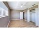 Bright bedroom with wood-look floors, a closet, and neutral paint, enhanced by natural light at 7903 Hyde Park Ave, North Port, FL 34287