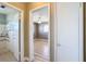 View from hallway to bathroom and into a bedroom, both featuring consistent flooring at 7903 Hyde Park Ave, North Port, FL 34287