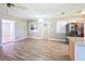 Bright and spacious living room with stainless steel refrigerator and modern lighting at 7903 Hyde Park Ave, North Port, FL 34287