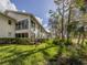 Exterior view of the house with a well-manicured lawn and trees at 805 Montrose Dr # 203, Venice, FL 34293