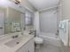 All-white bathroom featuring a tub, shower, and extended vanity at 805 Montrose Dr # 203, Venice, FL 34293