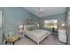 Cozy bedroom with a ceiling fan, a large window, and light blue walls at 805 Montrose Dr # 203, Venice, FL 34293