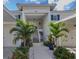 Inviting condo entrance featuring vibrant landscaping, walkway, and well-maintained stairs to the units at 805 Montrose Dr # 203, Venice, FL 34293