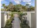 View from condo entrance, showcasing covered parking and beautifully landscaped surroundings at 805 Montrose Dr # 203, Venice, FL 34293