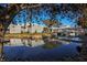 Building exterior reflected in pond, showcasing landscaping and architectural design at 805 Montrose Dr # 203, Venice, FL 34293