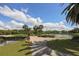 Scenic view of community golf course with pond and lush landscaping at 805 Montrose Dr # 203, Venice, FL 34293