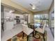 Open kitchen and dining area featuring stainless steel appliances, white cabinetry, and outdoor views at 805 Montrose Dr # 203, Venice, FL 34293