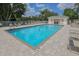 Inviting community pool area featuring a pool house and plenty of lounge chairs for relaxing poolside at 805 Montrose Dr # 203, Venice, FL 34293