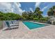 Relaxing community pool area with brick pavers, lounge chairs and landscaping providing a private oasis at 805 Montrose Dr # 203, Venice, FL 34293