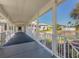 Covered walkway offers views of lush landscaping and a serene pond with a fountain at 805 Montrose Dr # 203, Venice, FL 34293