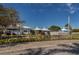 Community clubhouse overlooking serene pond with fountain and meticulously maintained landscaping at 805 Montrose Dr # 203, Venice, FL 34293