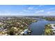 Aerial view of canal-front home with mature landscaping and dock; located on a waterfront lot at 807 Lucille Ave, Nokomis, FL 34275