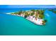 Gorgeous aerial view of a beach with white sand, clear blue water, a pier and ample parking at 807 Lucille Ave, Nokomis, FL 34275