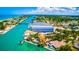 Picturesque aerial view featuring waterfront houses with pools, a beach and a large marina building at 807 Lucille Ave, Nokomis, FL 34275