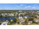 Aerial view of canal-front home with mature landscaping and dock; located on a waterfront lot at 807 Lucille Ave, Nokomis, FL 34275