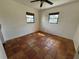 A bright bedroom featuring unique tile flooring and natural light from two windows at 807 Lucille Ave, Nokomis, FL 34275