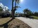 Inviting single-story home with a shell driveway, complemented by a gazebo and mature trees at 807 Lucille Ave, Nokomis, FL 34275