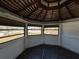 Interior of gazebo, with wood ceiling, floor, and 3 windows at 807 Lucille Ave, Nokomis, FL 34275